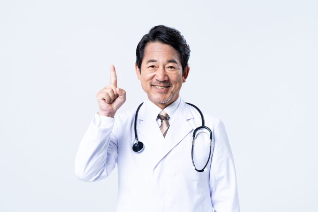 人差し指を立てている男性医師